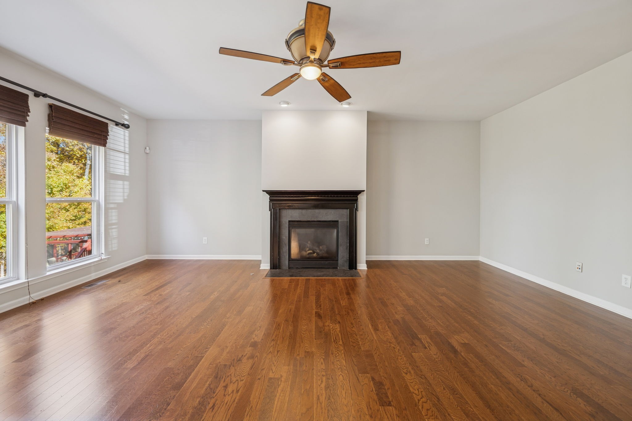 322 Forest Bend Drive Mount Juliet, TN 37122 - Photo 15 of 62 a view of an empty room with wooden floor fireplace and a window