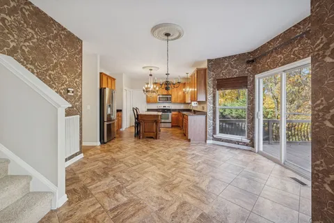 a kitchen with granite countertop a sink appliances cabinets and furniture