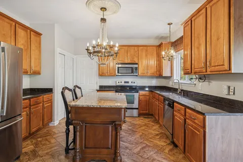 a view of a livingroom with wooden floor and staircase