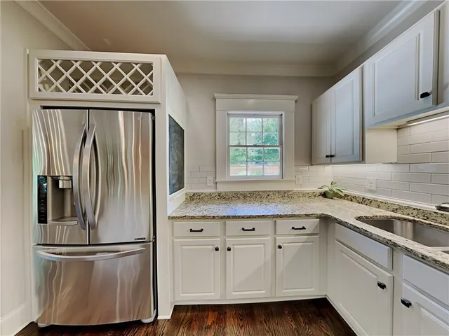 a kitchen with stainless steel appliances granite countertop a refrigerator sink and cabinets