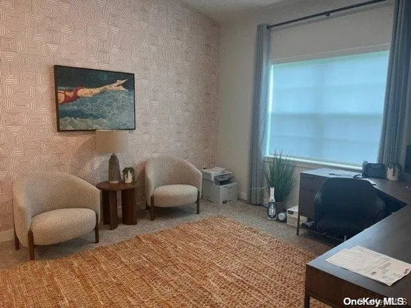 a living room with furniture a window and a flat screen tv