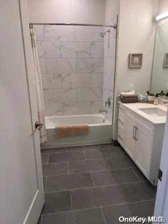 a bathroom with a bathtub a sink and a shower