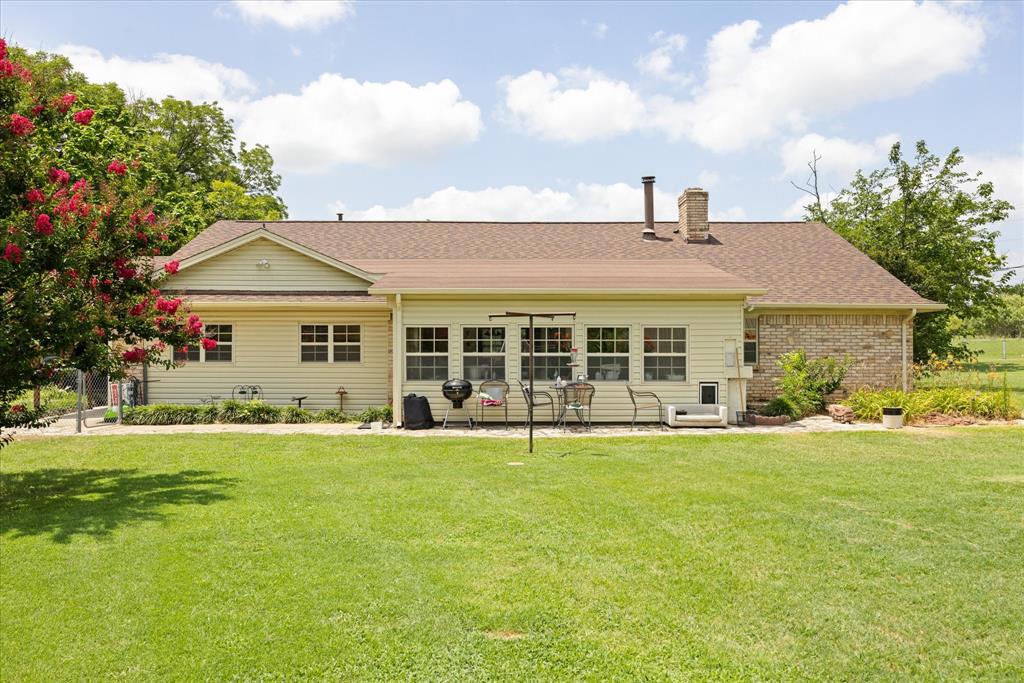 4210 Waples Road Granbury, TX 76049 - Photo 2 of 37 Expansive rear lawn with a cream-colored siding and brick facade