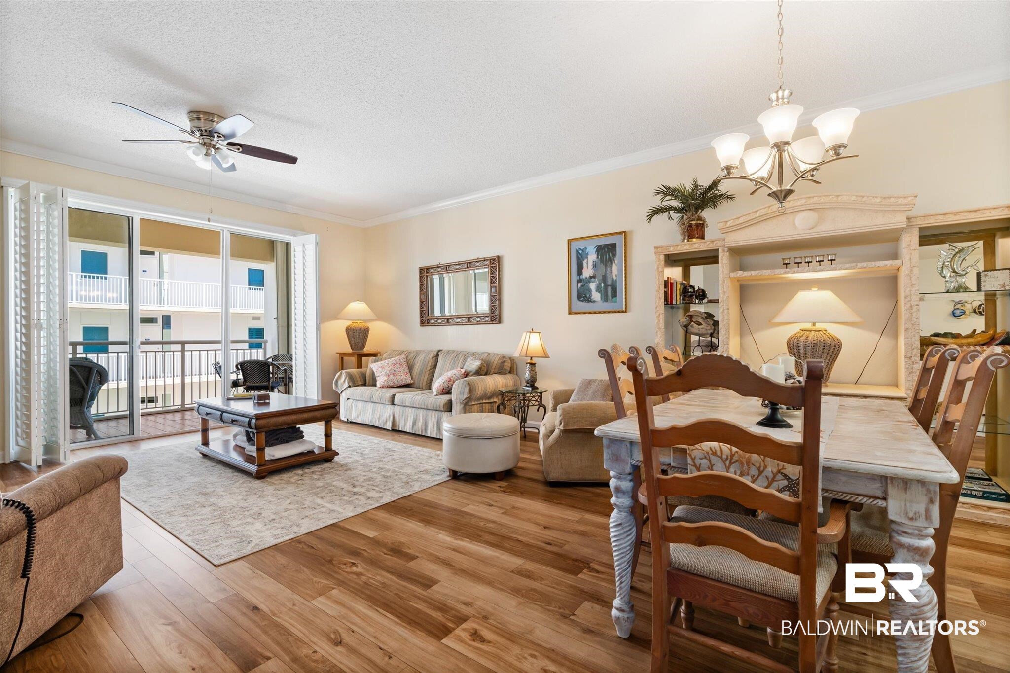 27770 Canal Road, Unit 2304 Orange Beach, AL 36561 - Photo 11 of 30 Living area featuring a textured ceiling, ornamental molding, ceiling fan with notable chandelier, and wood finished floors
