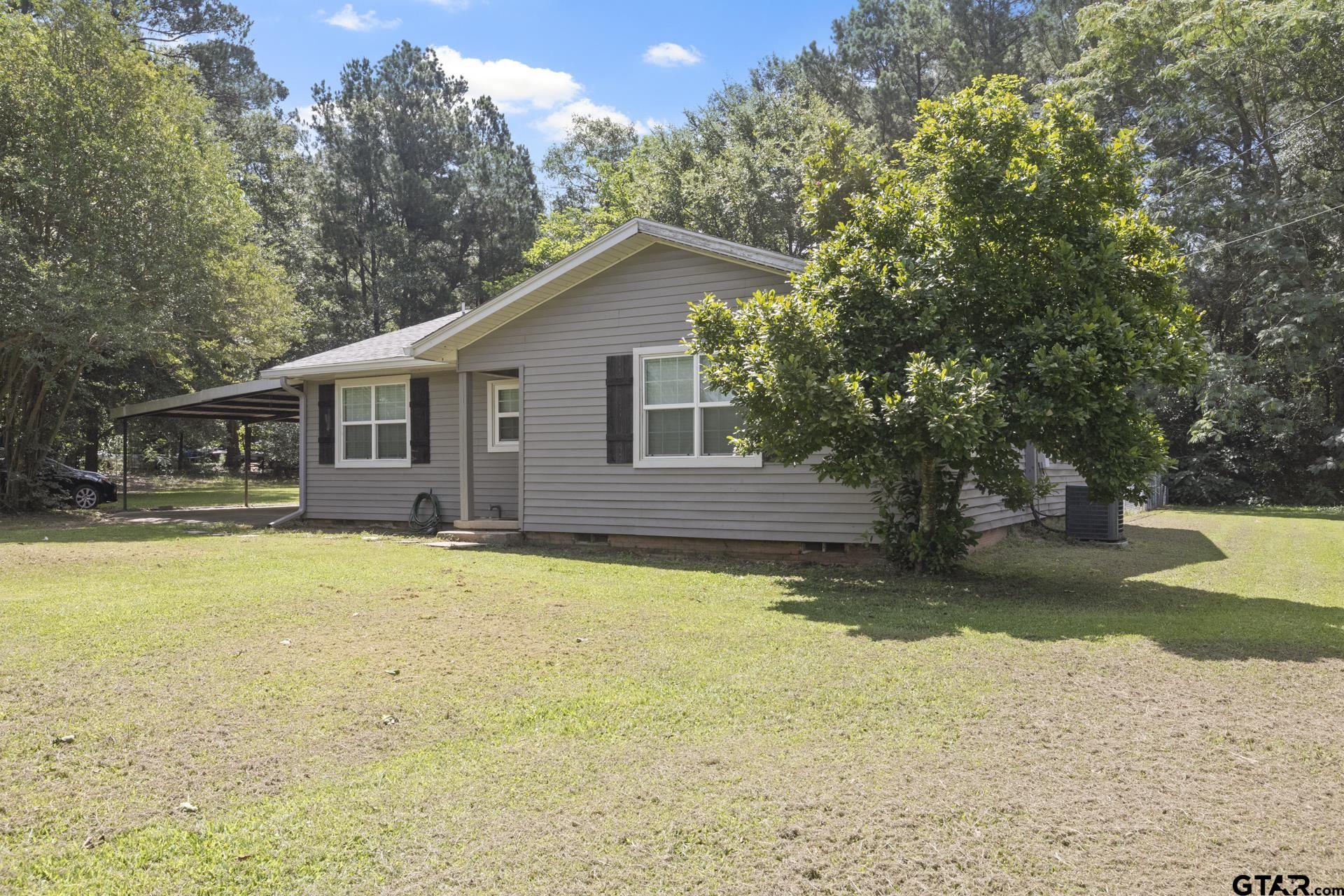 a view of a house with pool and a yard