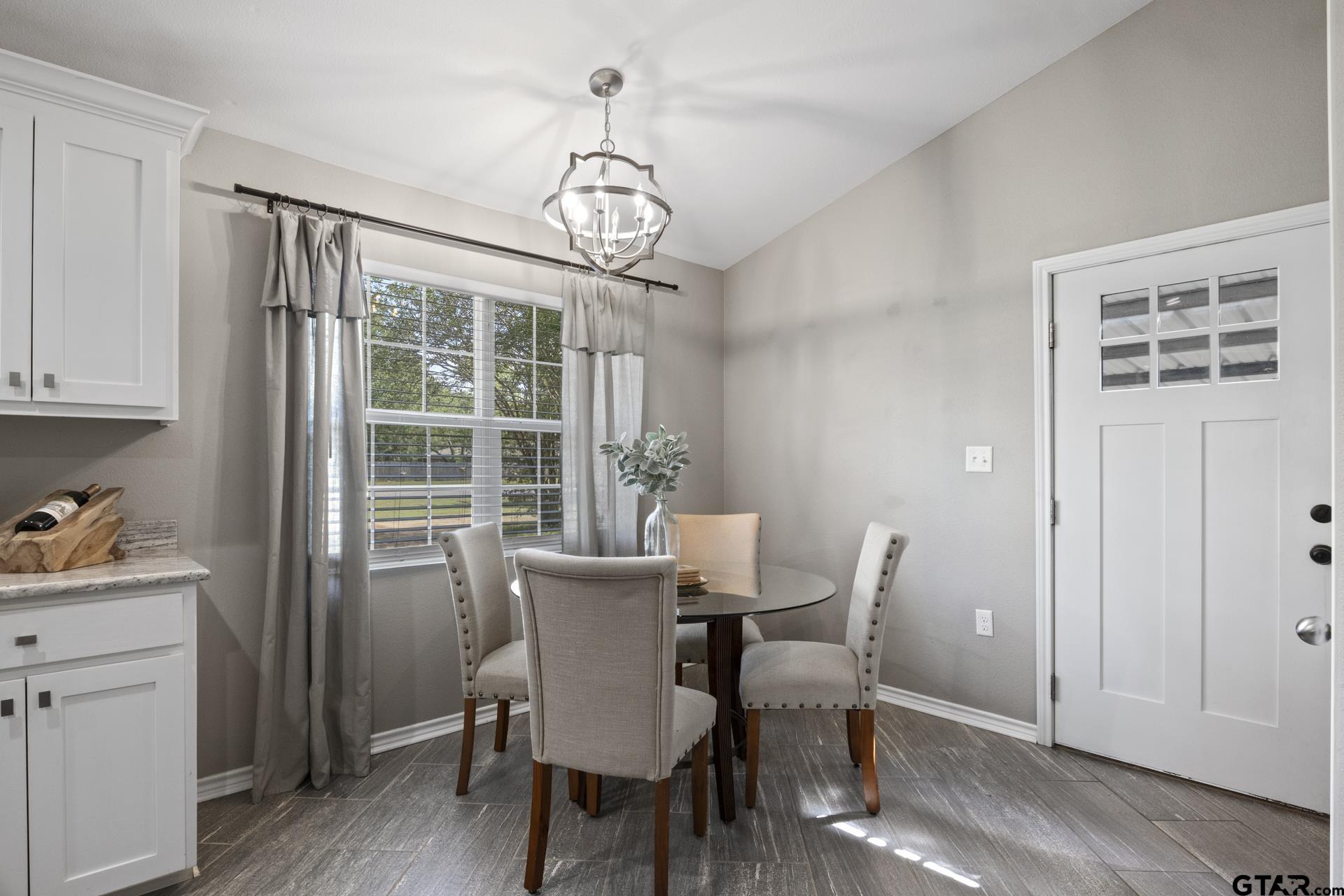 655 Daingerfield Street Pittsburg, TX 75686 - Photo 11 of 27 a view of a dining room with furniture window and wooden floor