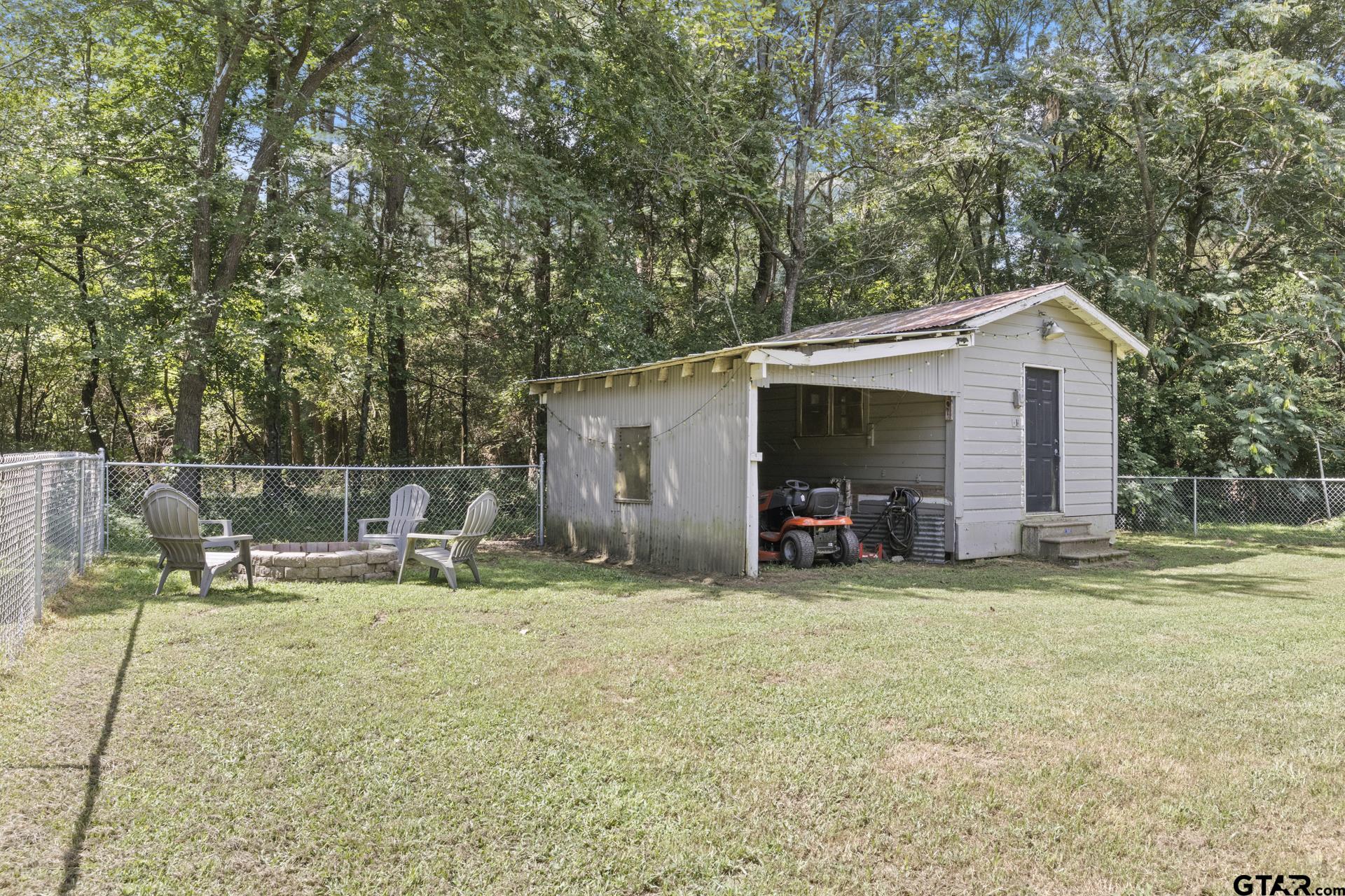 655 Daingerfield Street Pittsburg, TX 75686 - Photo 17 of 27 a view of a house with backyard and sitting area
