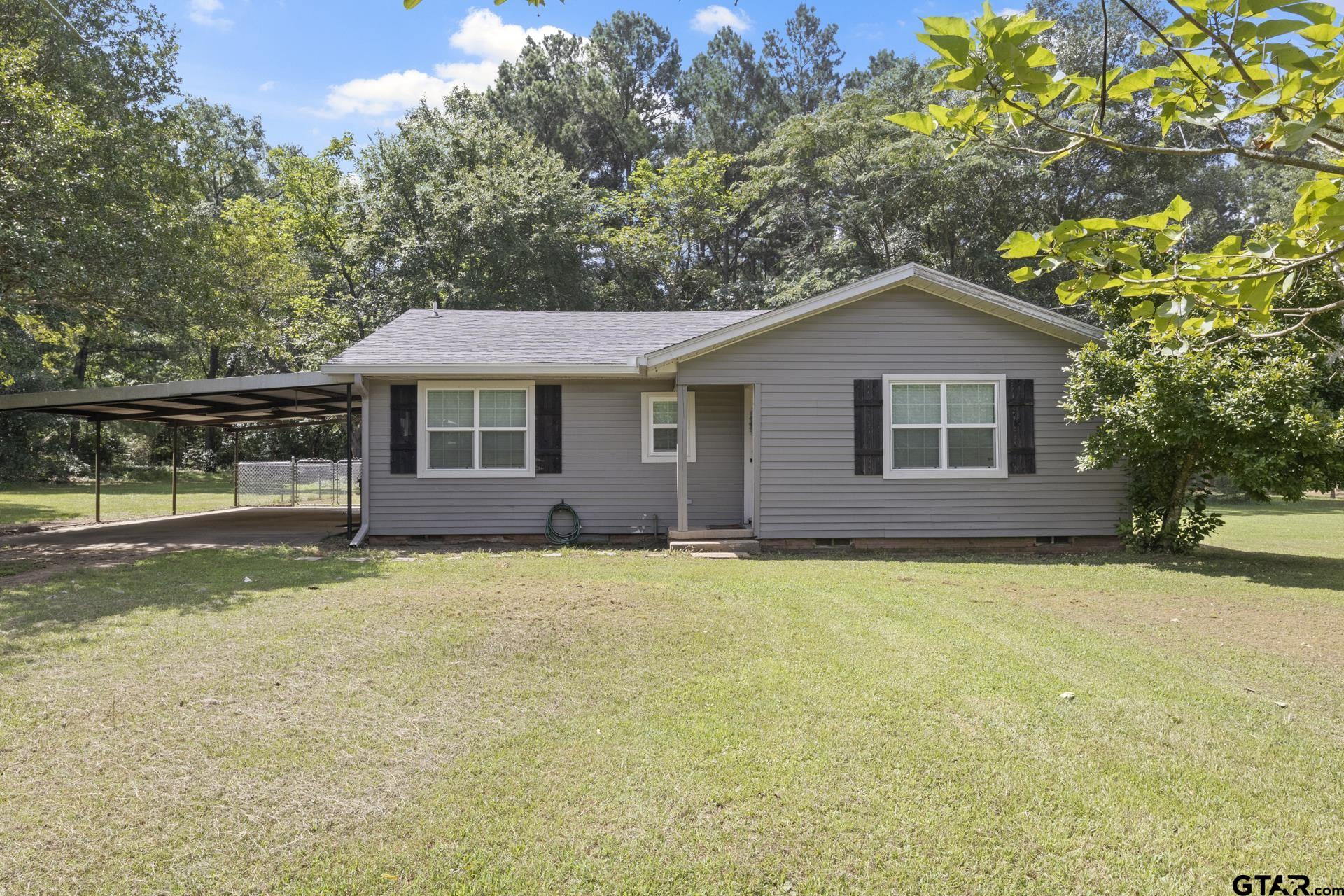 655 Daingerfield Street Pittsburg, TX 75686 - Photo 21 of 27 a front view of a house with a garden