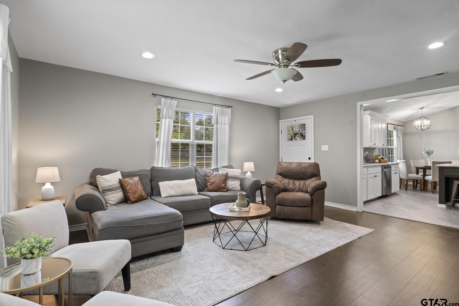 655 Daingerfield Street Pittsburg, TX 75686 - Photo 4 of 27 a living room with furniture and a large window