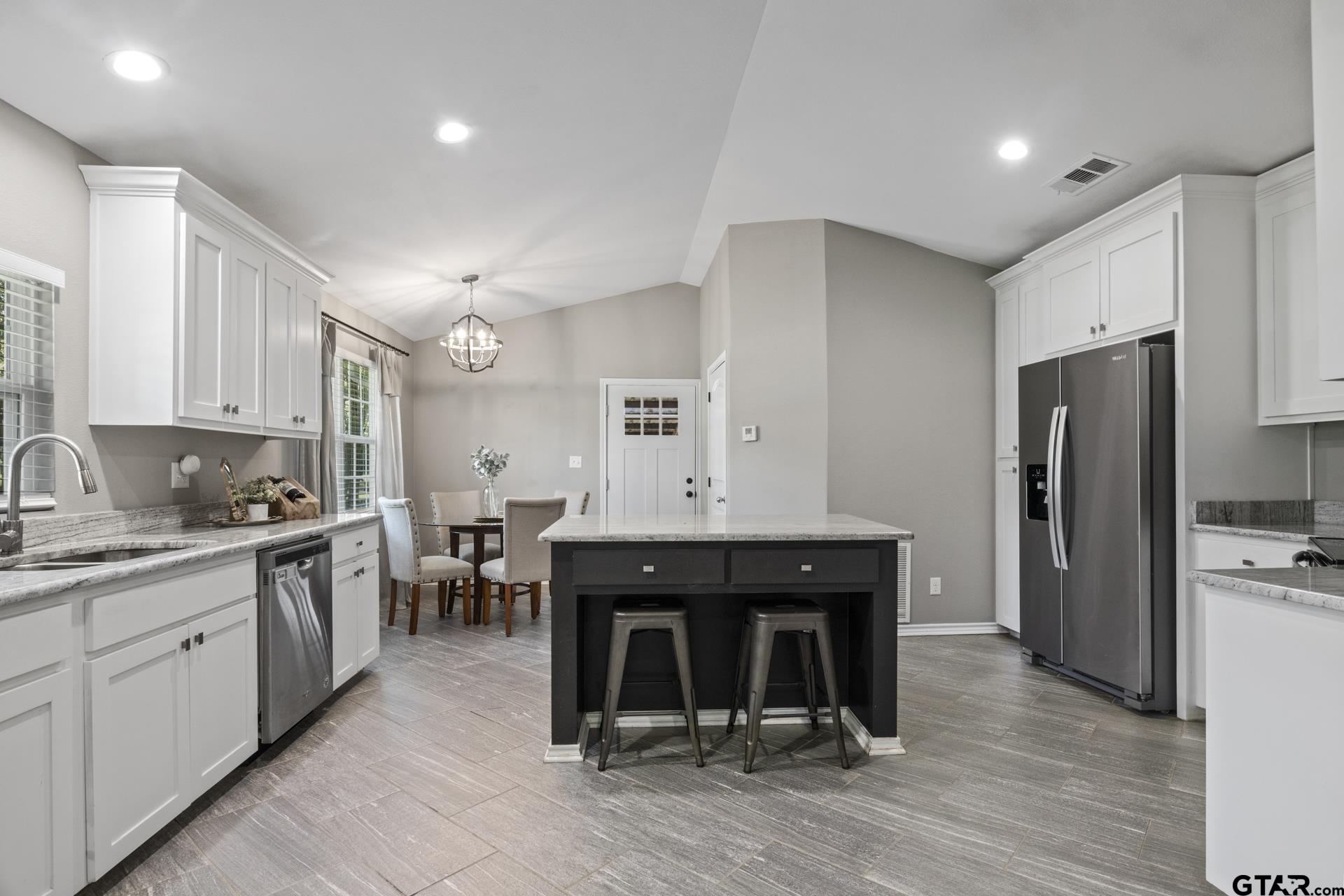 655 Daingerfield Street Pittsburg, TX 75686 - Photo 6 of 27 a kitchen with a sink refrigerator and cabinets