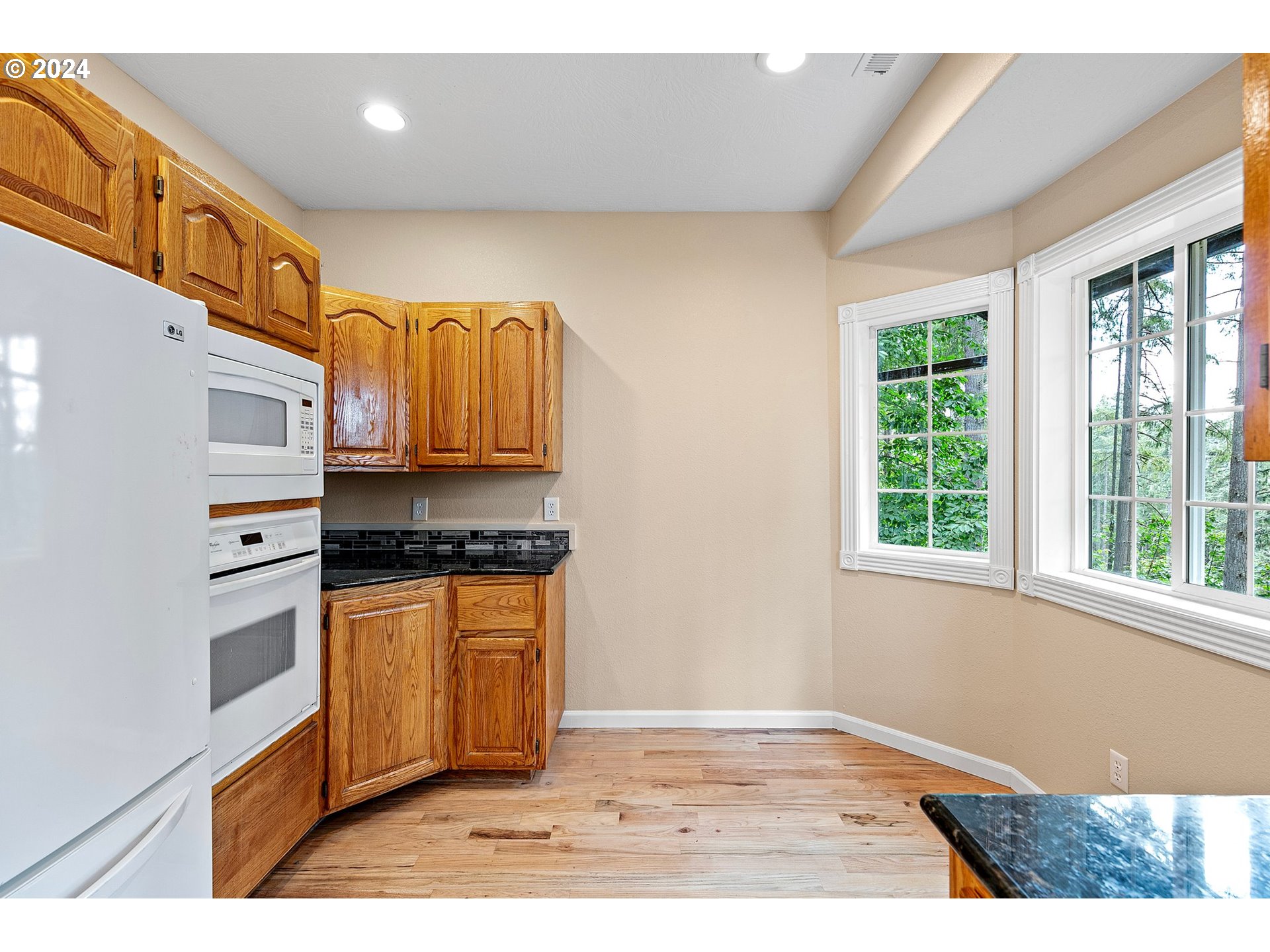 626 South 73rd Street Springfield, OR 97478 - Photo 13 of 46 a kitchen with stainless steel appliances granite countertop a stove a sink and a microwave