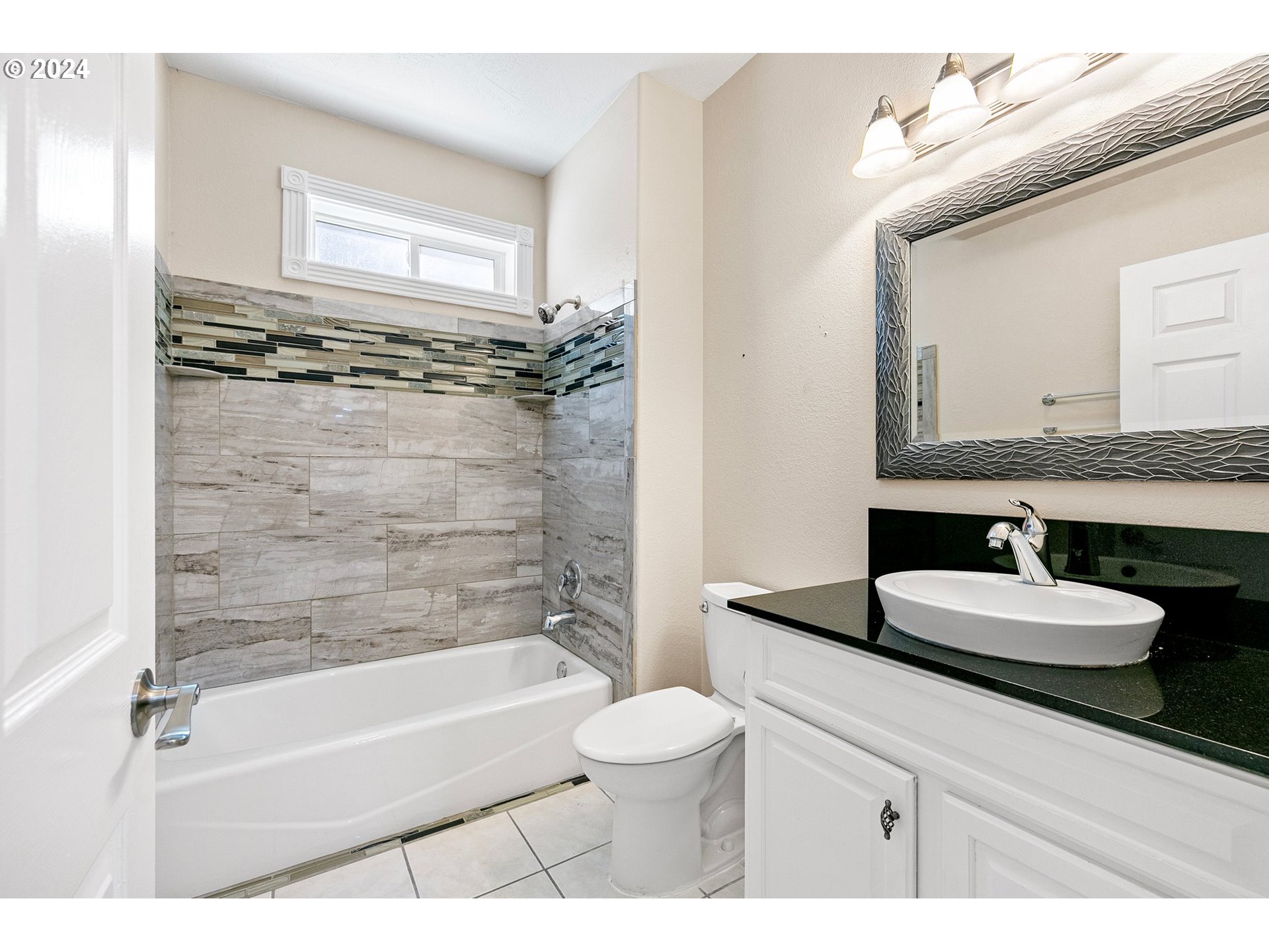 626 South 73rd Street Springfield, OR 97478 - Photo 38 of 46 a bathroom with a granite countertop sink toilet a mirror and bathtub