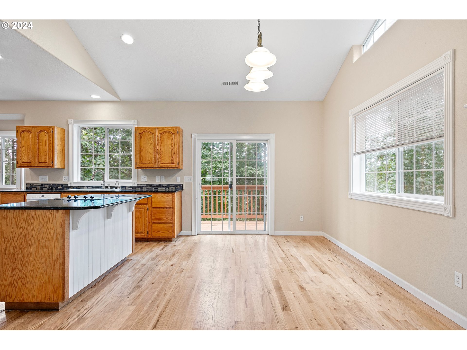 626 South 73rd Street Springfield, OR 97478 - Photo 6 of 46 a open kitchen with granite countertop a sink window and wooden floor