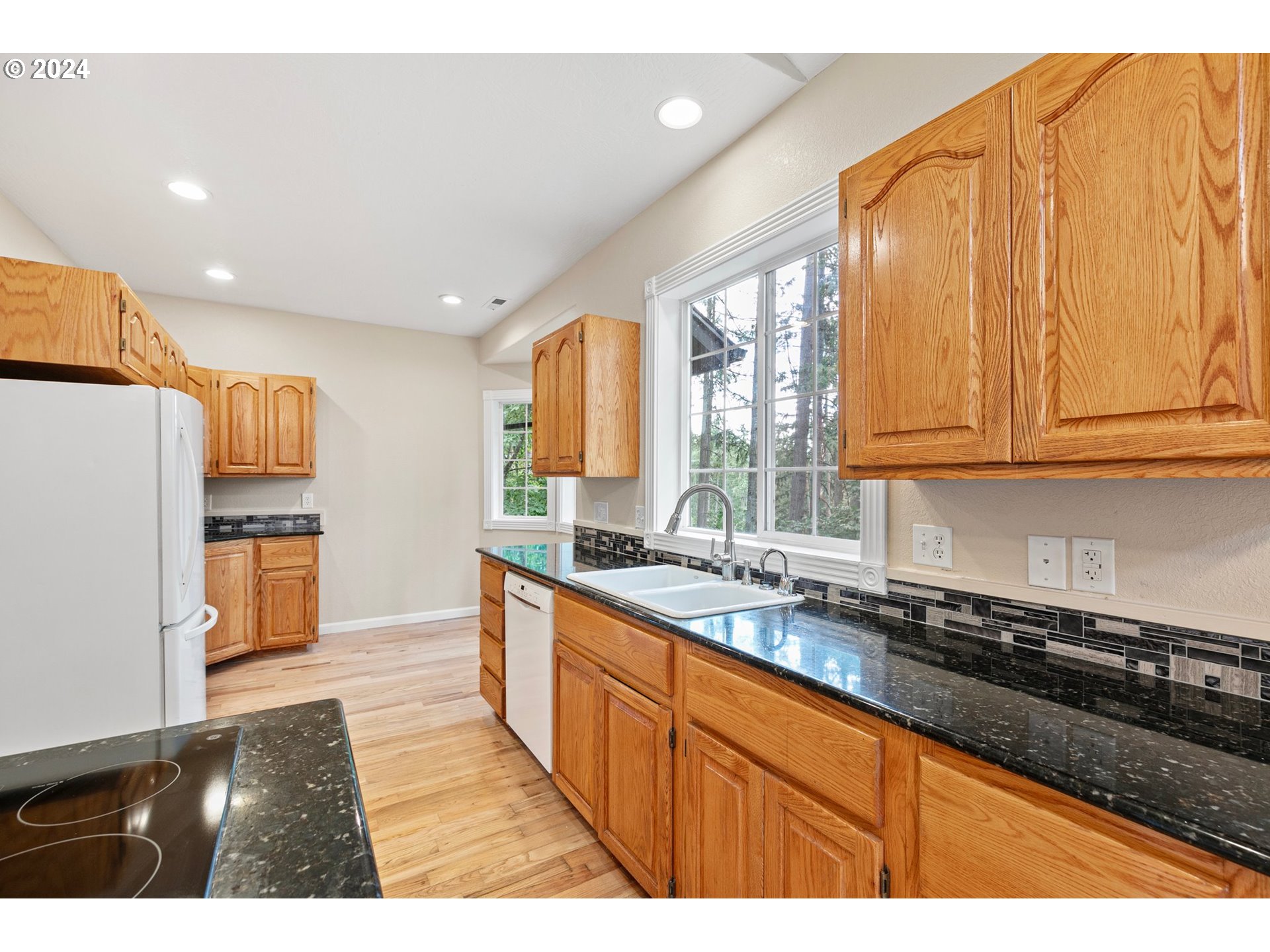 626 South 73rd Street Springfield, OR 97478 - Photo 10 of 46 a kitchen with stainless steel appliances granite countertop a stove a sink and a refrigerator
