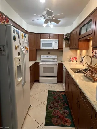 a kitchen with stainless steel appliances granite countertop a refrigerator and a stove