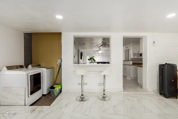 a view of kitchen with faucet and refrigerator