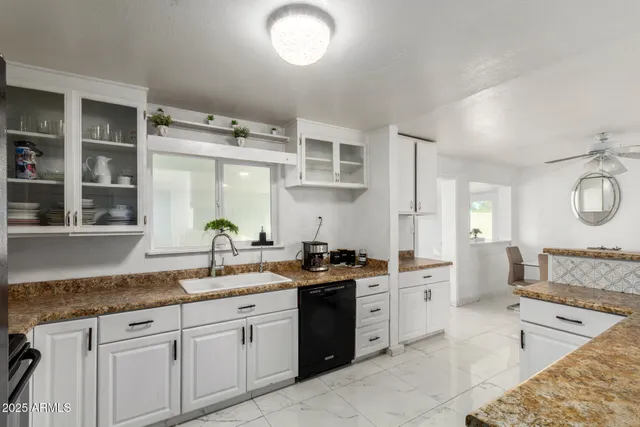 a kitchen with a sink stove and cabinets