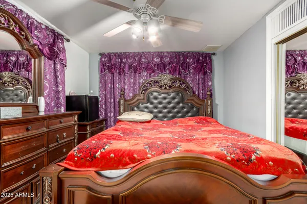 a bedroom with a bed and a chandelier