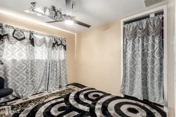 a bedroom with a bed and a curtain