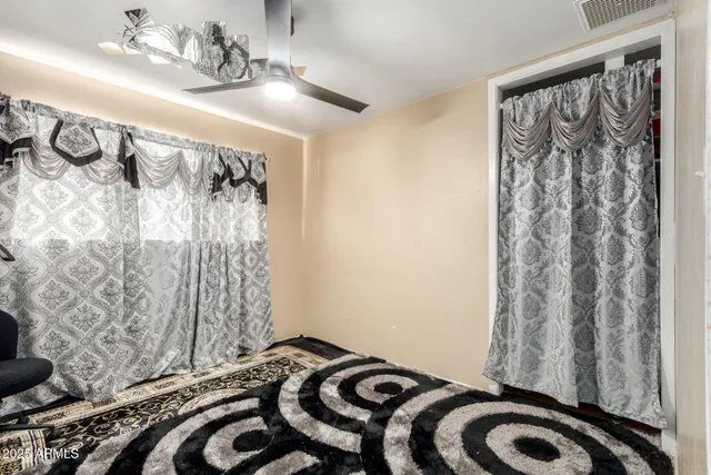 a bedroom with a bed and a curtain