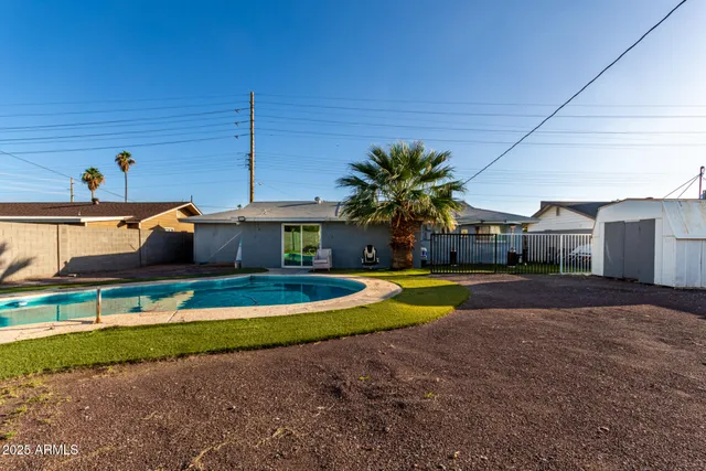 a swimming pool with outdoor seating and yard