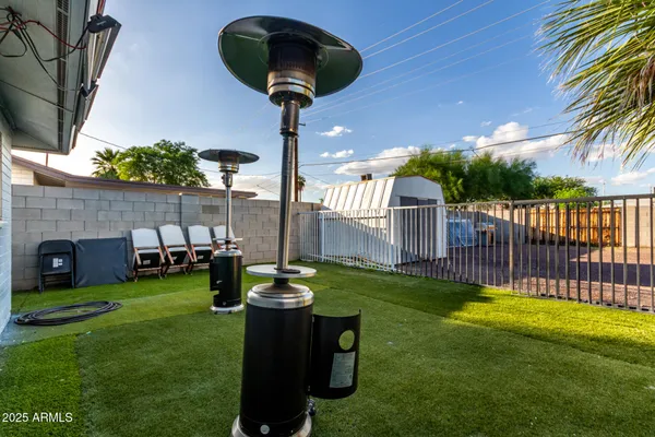 a front view of a house with garden bath tub and trees