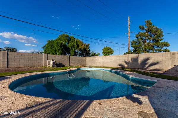 a view of a swimming pool with a patio