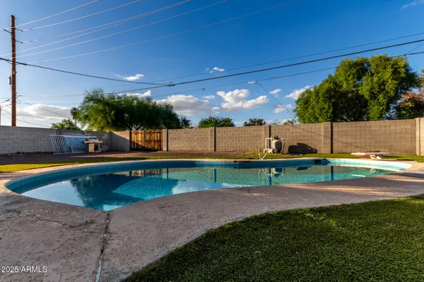 a view of a swimming pool with a yard