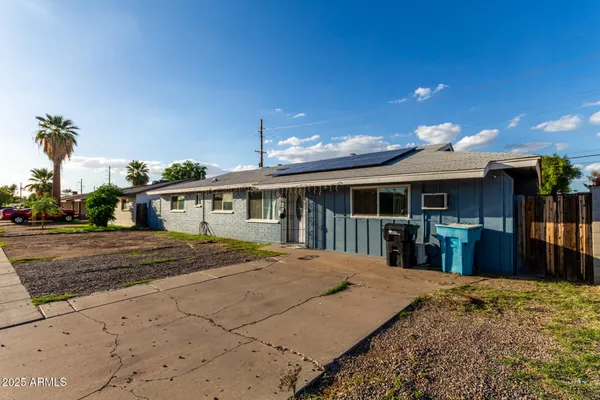 a front view of a house with a yard outdoor seating and covered with snow