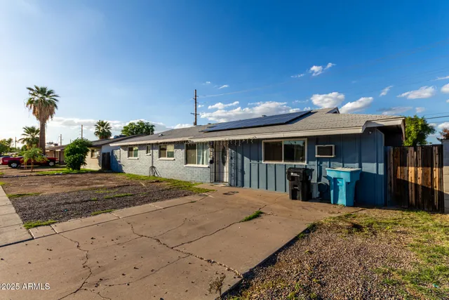a front view of a house with a yard outdoor seating and covered with snow