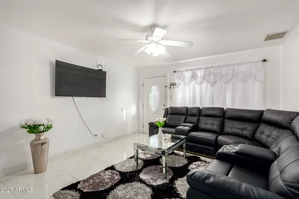 a living room with furniture and a flat screen tv