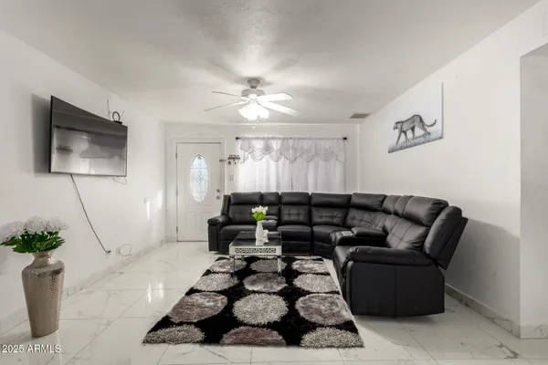 a living room with furniture and a flat screen tv
