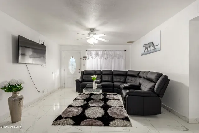 a living room with furniture and a flat screen tv