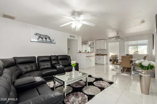a living room with furniture and a chandelier
