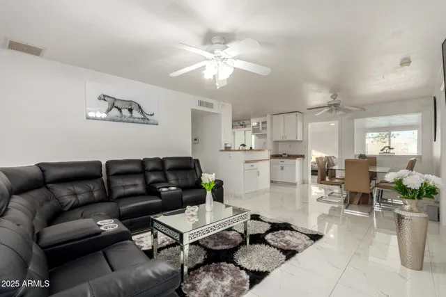 a living room with furniture and a chandelier