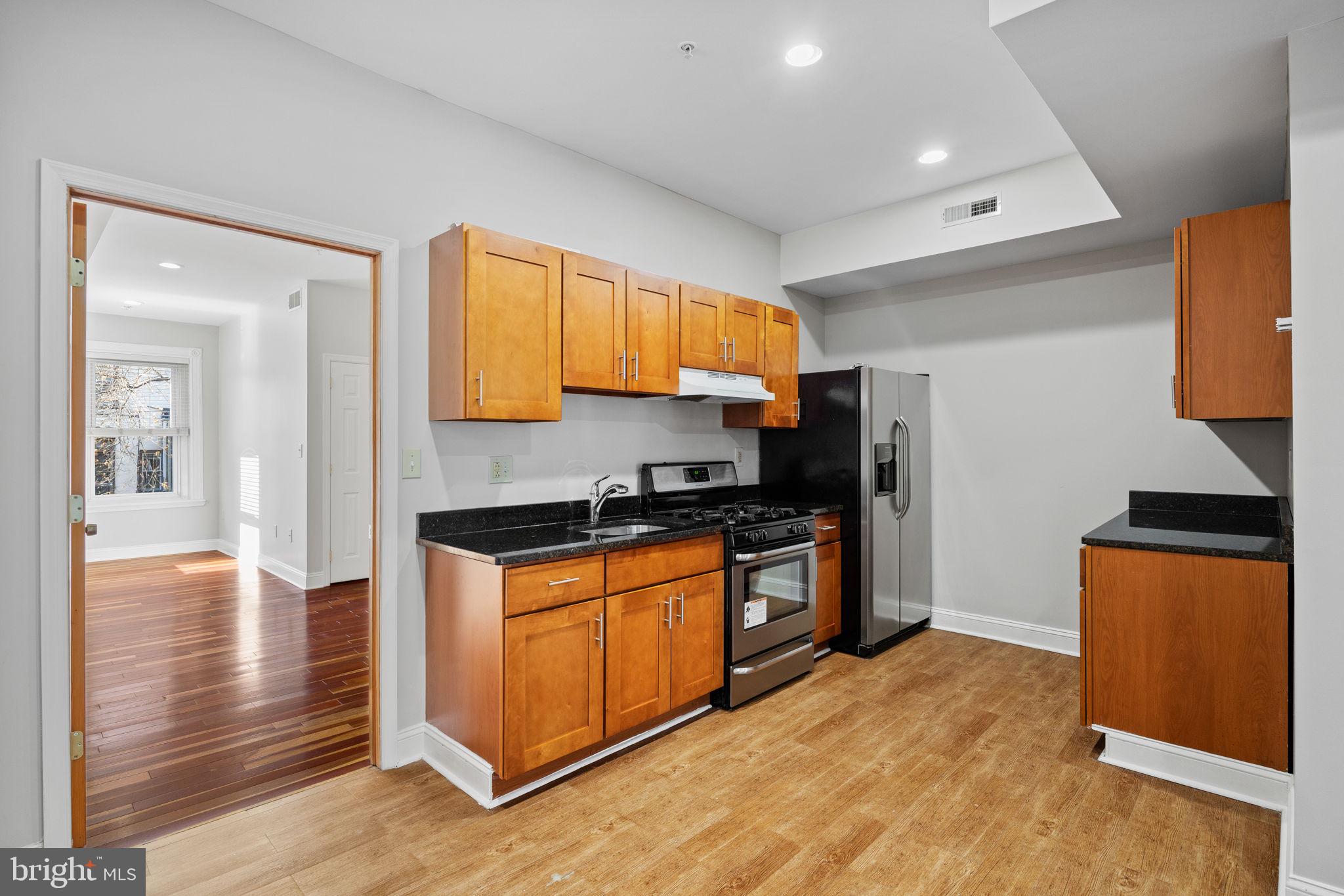 426 South 44th Street, Unit 2 Philadelphia, PA 19104 - Photo 14 of 29 a kitchen with stainless steel appliances granite countertop a stove a sink and a refrigerator