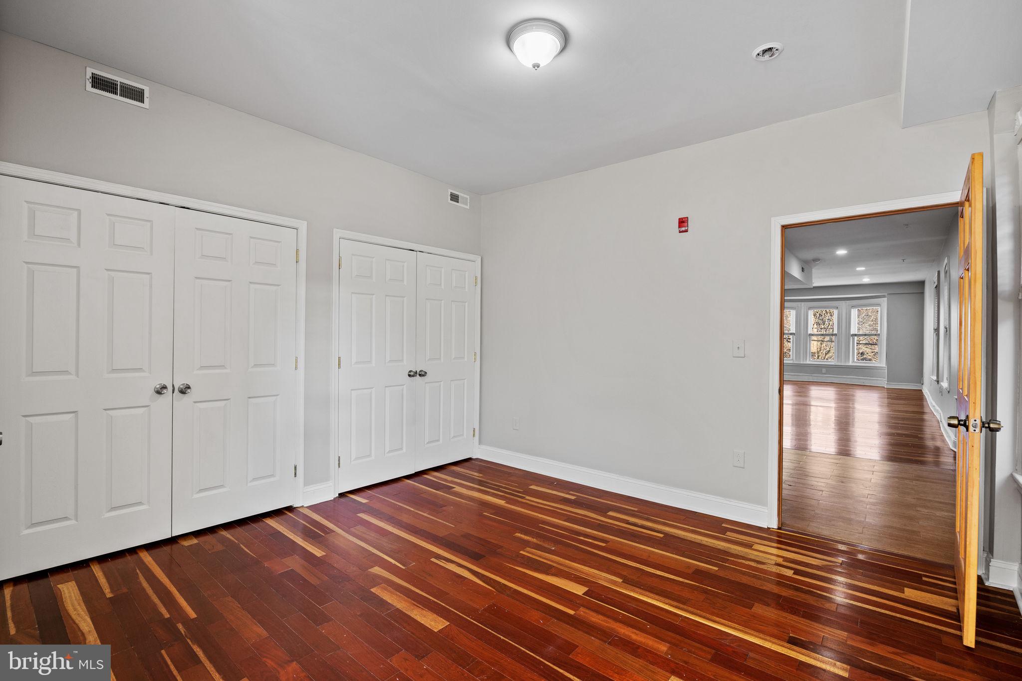 426 South 44th Street, Unit 2 Philadelphia, PA 19104 - Photo 18 of 29 a view of an empty room with window and wooden floor