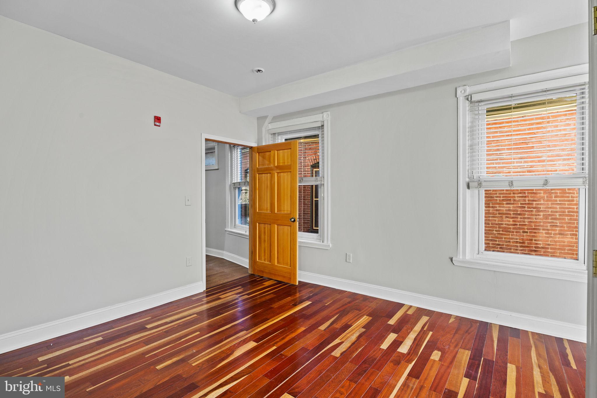 426 South 44th Street, Unit 2 Philadelphia, PA 19104 - Photo 22 of 29 a view of an empty room with wooden floor and a window