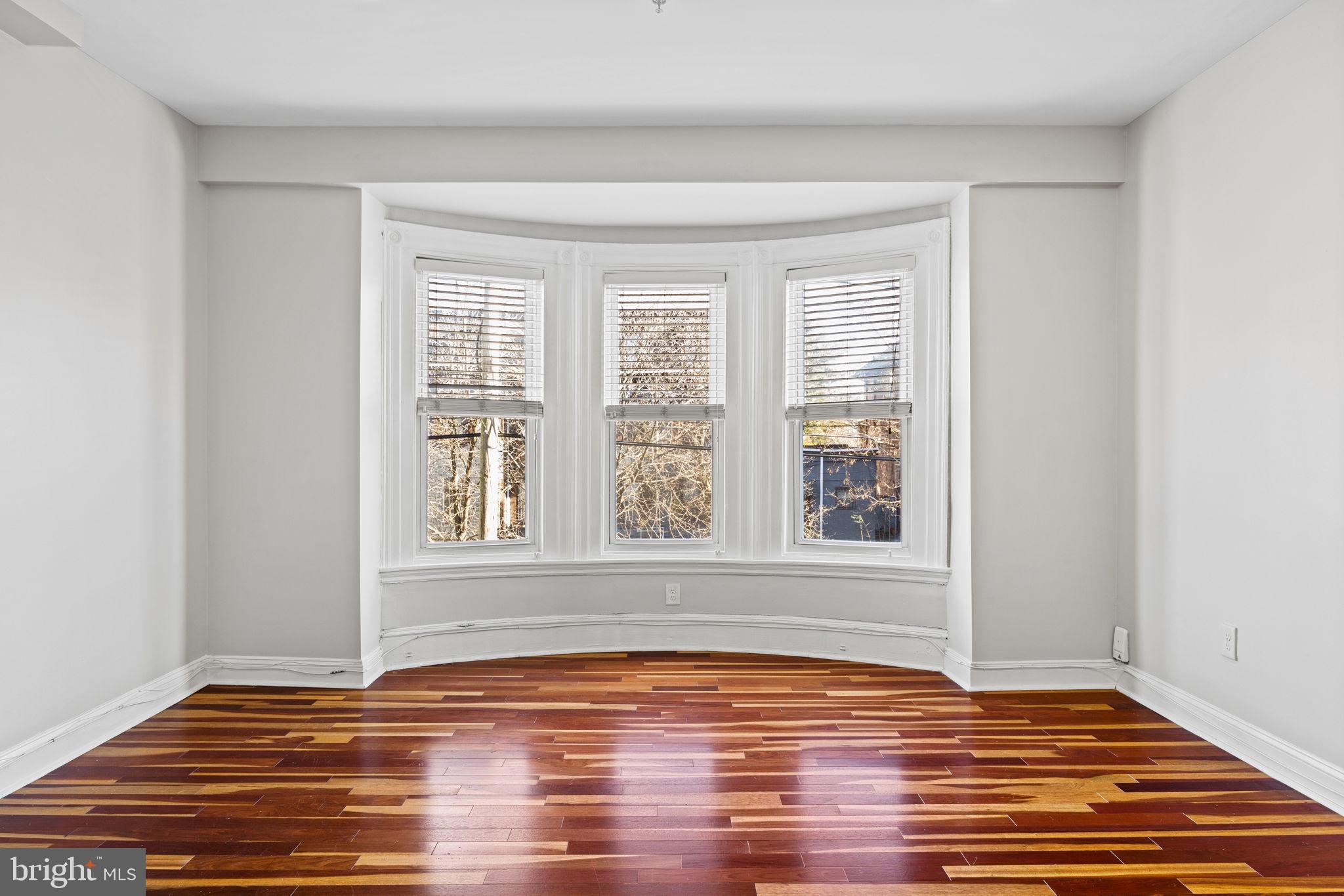 426 South 44th Street, Unit 2 Philadelphia, PA 19104 - Photo 9 of 29 a view of an empty room with wooden floor and a window