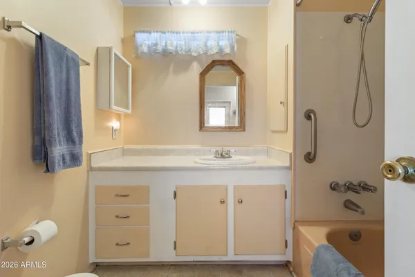 a view of a swimming pool with outdoor seating and buildings in the background