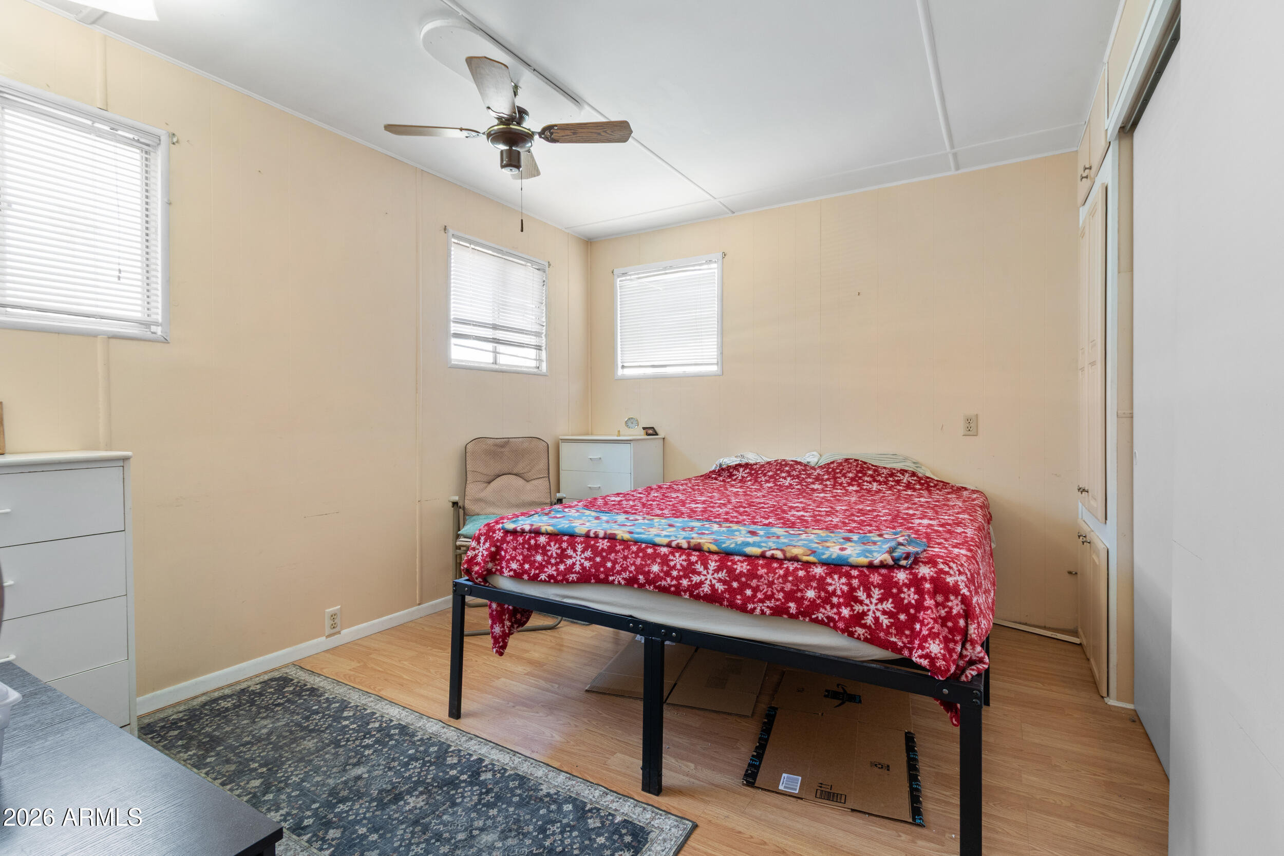 701 South Dobson Road, Unit 343 Mesa, AZ 85202 - Photo 17 of 70 a bedroom with a bed a chandelier and a window