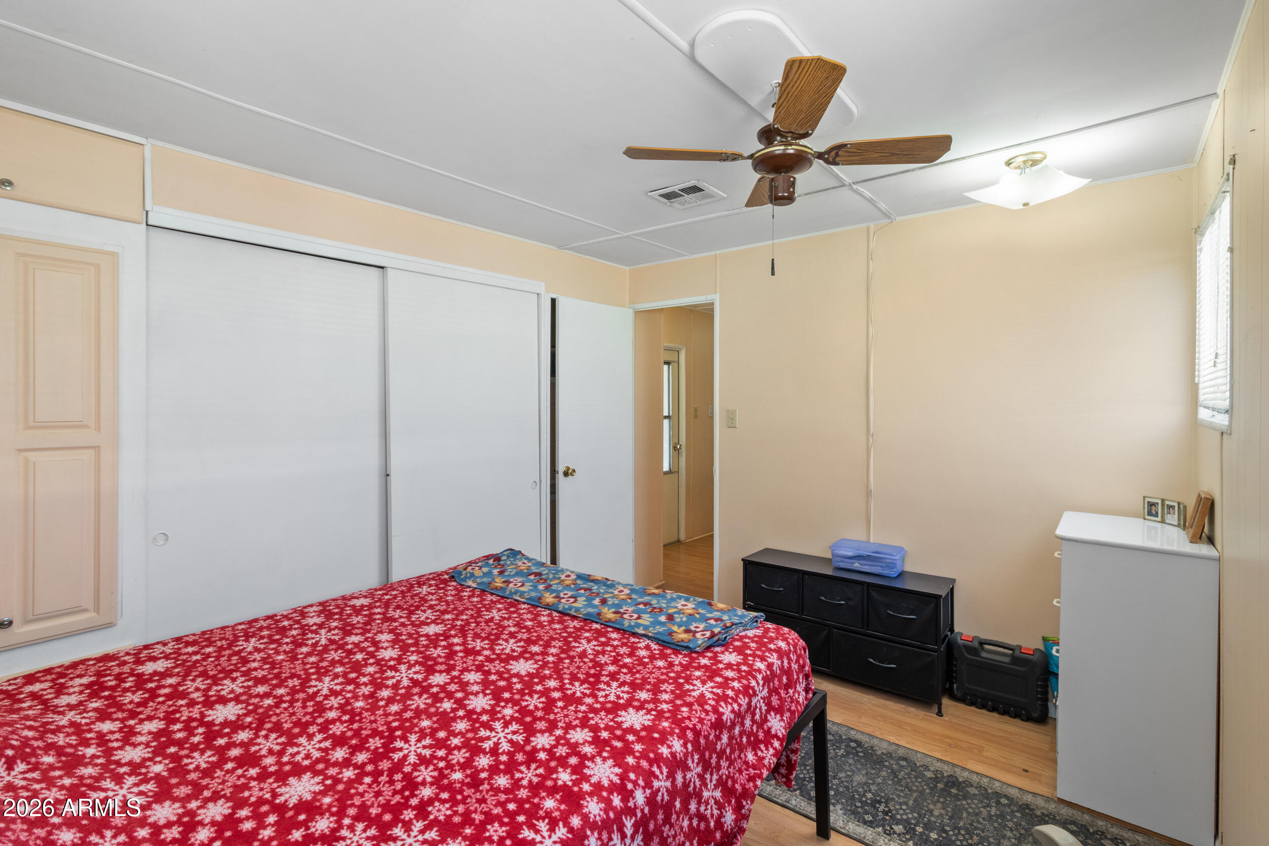 701 South Dobson Road, Unit 343 Mesa, AZ 85202 - Photo 19 of 70 a bedroom with a bed and a chandelier