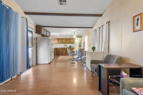 a kitchen with stainless steel appliances granite countertop a refrigerator a stove a sink dishwasher and white cabinets with wooden floor