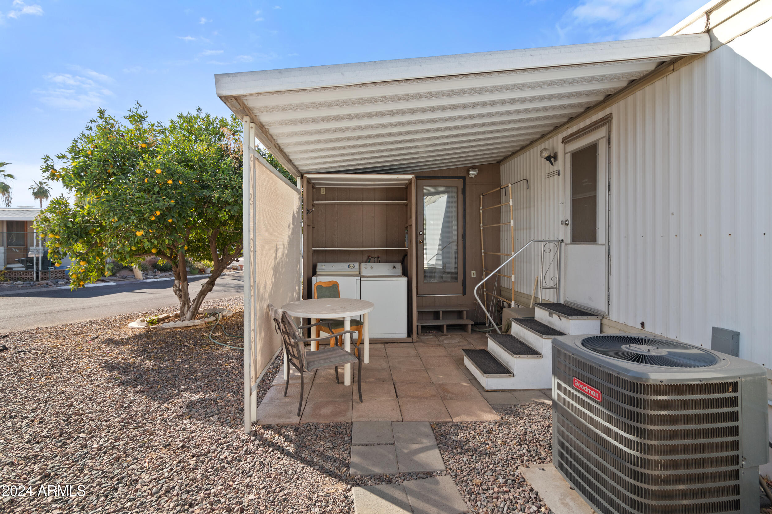 701 South Dobson Road, Unit 343 Mesa, AZ 85202 - Photo 62 of 70 a backyard of a house with table and chairs