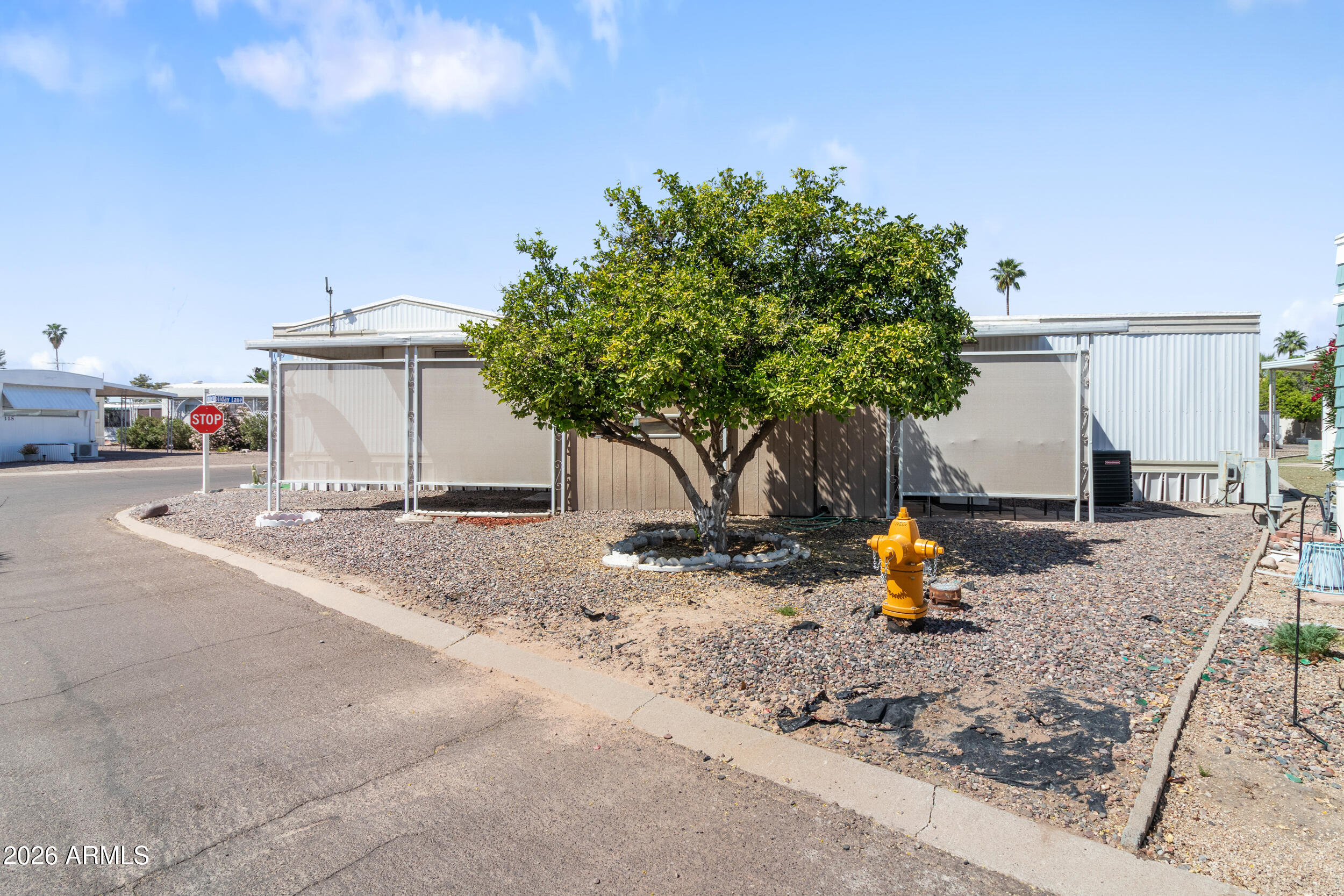701 South Dobson Road, Unit 343 Mesa, AZ 85202 - Photo 64 of 70 a backyard of a house with table and chairs