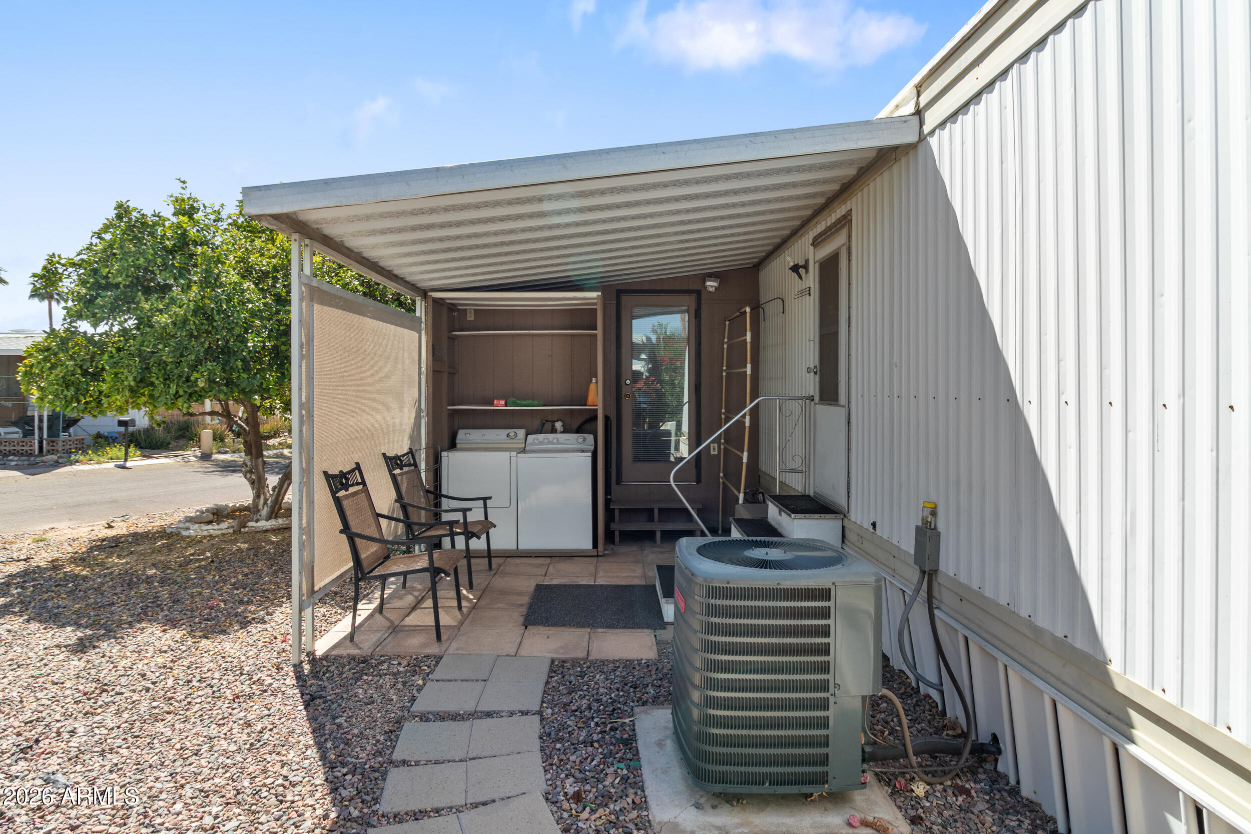 701 South Dobson Road, Unit 343 Mesa, AZ 85202 - Photo 65 of 70 a view of a patio with table and chairs with wooden floor and fence