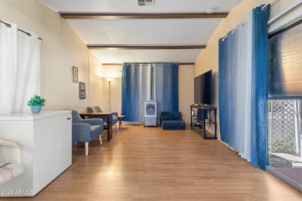 a kitchen with stainless steel appliances a refrigerator a stove a sink dishwasher and white cabinets with wooden floor