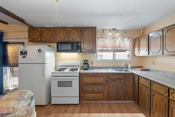 a bedroom with a bed a chandelier and a window