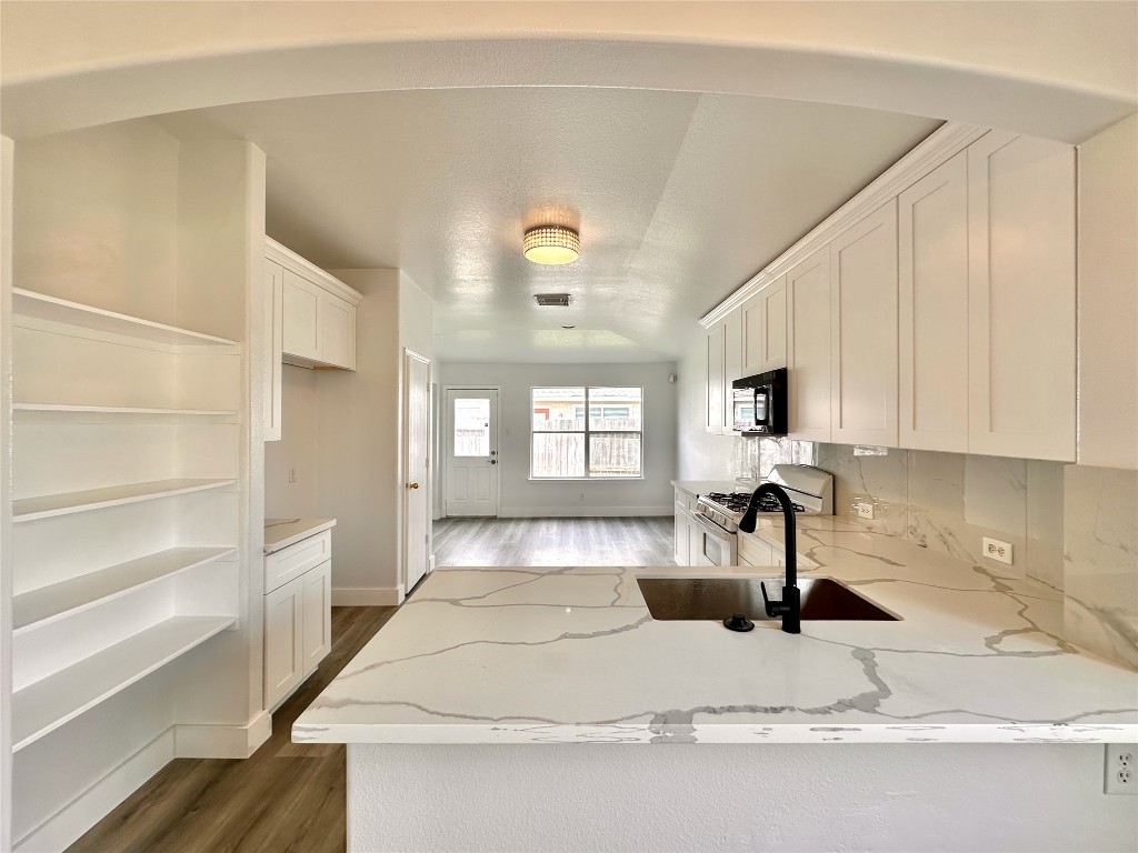 8202 Radial Court Rosharon, TX 77583 - Photo 11 of 27 a large white kitchen with sink and a window