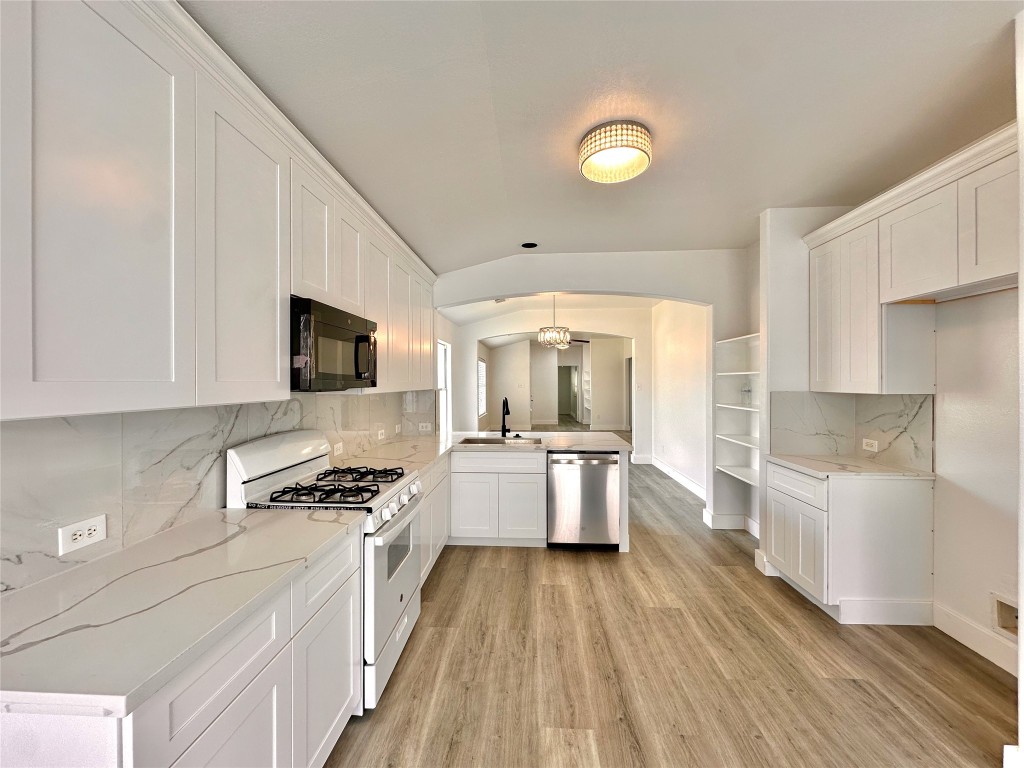 8202 Radial Court Rosharon, TX 77583 - Photo 13 of 27 a kitchen with a sink a counter top space stainless steel appliances and cabinets